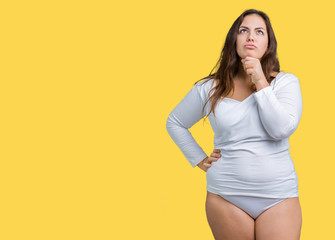 Obraz premium Beautiful plus size young overwight woman wearing white underwear over isolated background with hand on chin thinking about question, pensive expression. Smiling with thoughtful face. Doubt concept.