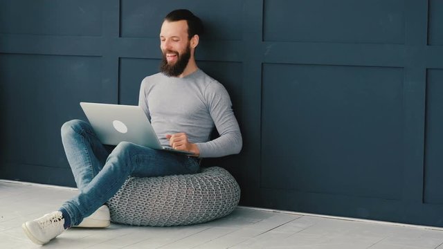 Blogger communication. Laughing man using laptop for video streaming or chatting. Sending love through online call.