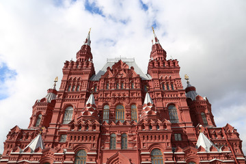 Fototapeta na wymiar Building of the State historical museum on Red square in Moscow against blue sky with white clouds. Russian architecture landmark