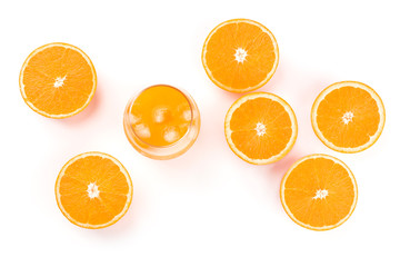 A glass of fresh orange juice with orange halves, shot from the top on a white background with a place for text