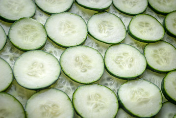 Fresh cucumber slices background. Sliced cucumber texture.