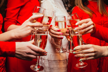 hands with glasses of champagne