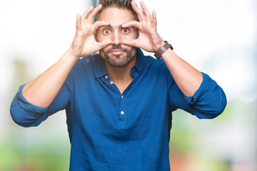 Young handsome man over isolated background Trying to open eyes with fingers, sleepy and tired for morning fatigue