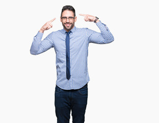 Young business man wearing glasses over isolated background Smiling pointing to head with both hands finger, great idea or thought, good memory