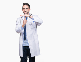 Handsome young doctor man over isolated background Doing time out gesture with hands, frustrated...