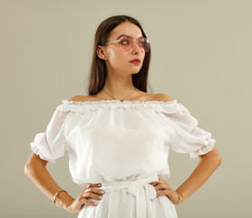 Slim young woman in white summer dress 