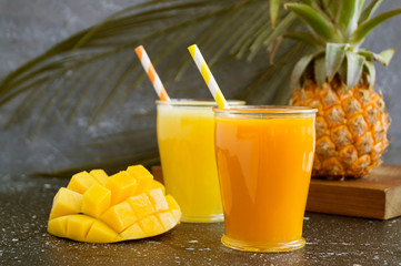 Pineapple juice in a jar with a straw.