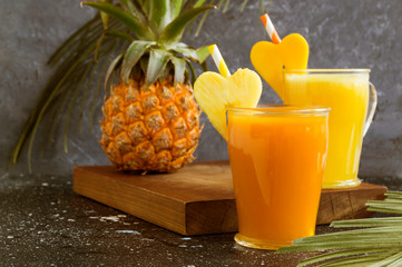 Pineapple juice in a jar with a straw.