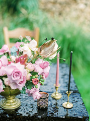 Elegant black and pink table setting for wedding reception with bouquets