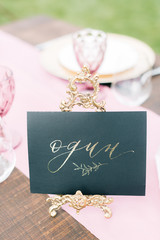 Elegant black and pink table setting for wedding reception with bouquets