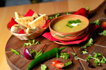 Cream soup in ceramic bowl on wooden table