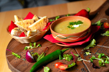 Cream soup in ceramic bowl on wooden table