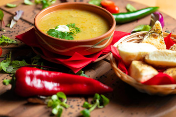 Cream soup in ceramic bowl on wooden table