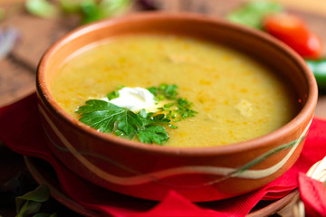 Cream soup in ceramic bowl on wooden table