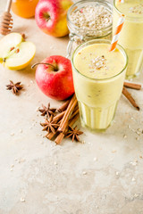 Healthy breakfast, snack. Spicy  smoothie with apple, honey, oatmeal, cinnamon, anise. Light concrete background copy space