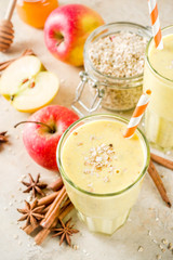 Healthy breakfast, snack. Spicy  smoothie with apple, honey, oatmeal, cinnamon, anise. Light concrete background copy space