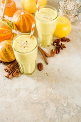 Healthy breakfast, snack. Spicy pumpkin smoothie with pumpkins, pecan nuts, honey, oatmeal, cinnamon, anise. Light concrete background copy space
