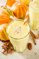 Healthy breakfast, snack. Spicy pumpkin smoothie with pumpkins, pecan nuts, honey, oatmeal, cinnamon, anise. Light concrete background copy space