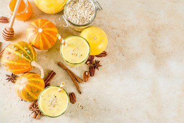 Healthy breakfast, snack. Spicy pumpkin smoothie with pumpkins, pecan nuts, honey, oatmeal, cinnamon, anise. Light concrete background copy space