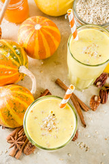 Healthy breakfast, snack. Spicy pumpkin smoothie with pumpkins, pecan nuts, honey, oatmeal, cinnamon, anise. Light concrete background copy space