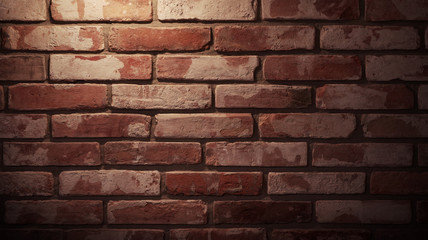 red textured brick wall with lighting.