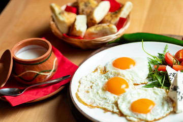 Fried eggs with cheese and tomatoes, breakfast