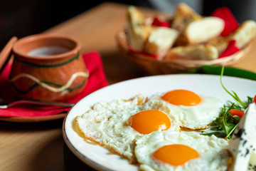 Fried eggs with cheese and tomatoes, breakfast