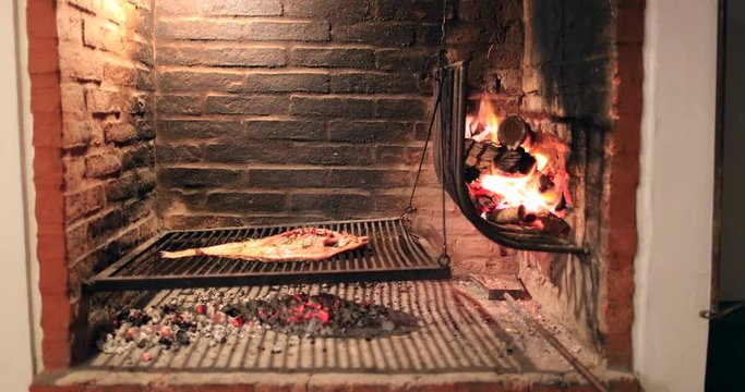 Fish on grill in traditional Uruguayan BBQ grill