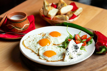 Fried eggs with cheese and tomatoes, breakfast