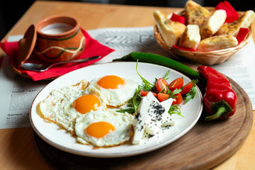 Fried eggs with cheese and tomatoes, breakfast