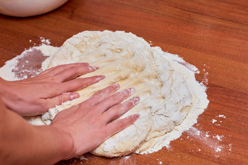 Dough for pizza on the wooden table, close-up. Dough for pizza.