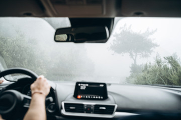 Man driving car with view from inside.
