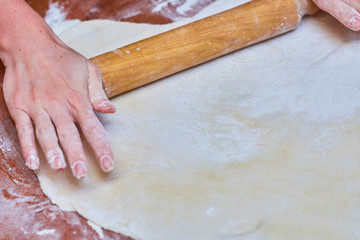 Dough for pizza on the wooden table, close-up. Dough for pizza.