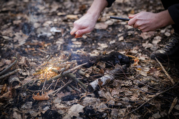 A man makes a fire with a flint