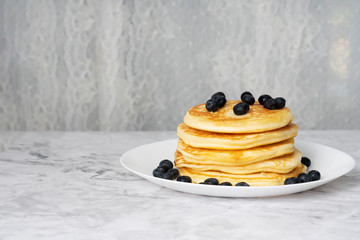 Pacakes and fresh blueberry fruit.