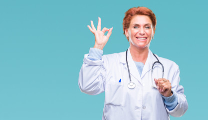 Senior caucasian doctor woman wearing medical uniform over isolated background smiling positive doing ok sign with hand and fingers. Successful expression.
