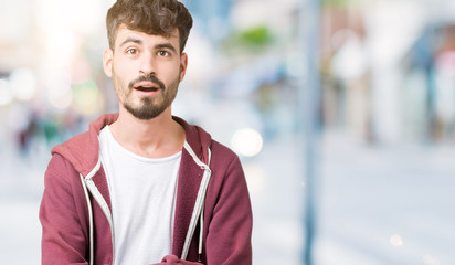 Fototapeta premium Young handsome man over isolated background afraid and shocked with surprise expression, fear and excited face.