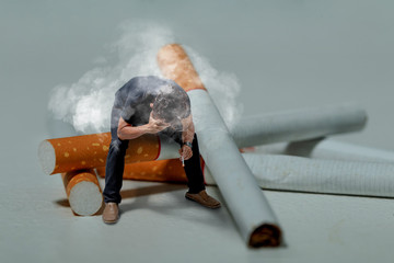 Smoking man are very stressed. He sat on a big cigarette.