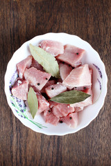 cooking pork for kebab with spices wooden table