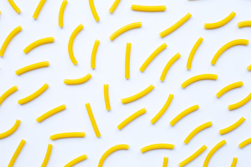 Uncooked macaroni on a white background.