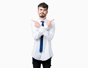 Young handsome business man wearing glasses over isolated background Pointing to both sides with fingers, different direction disagree
