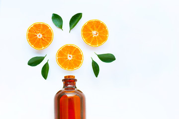 High vitamin C, Orange fruits with essential oil bottle on white background.