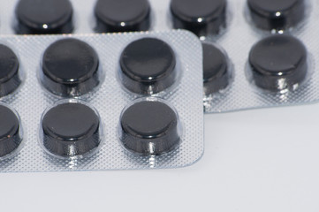 Tablets packaged on a white background, activated charcoal
