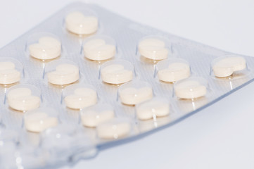 Heart pills in pack on white background