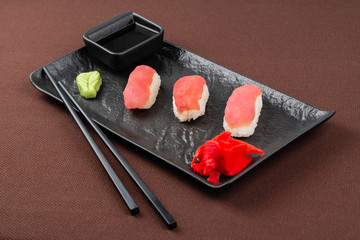 sushi on a black plate