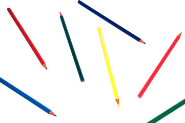 Color pencils scattered on white background top view. Can be used in the concept of education, school, training.
