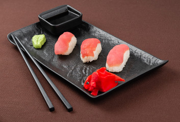 sushi on a black plate