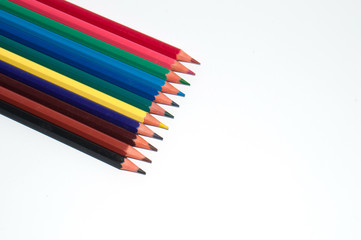 Fototapeta premium Color pencils on white background top view. At the bottom right there is place to insert text.