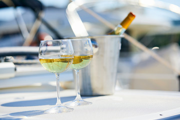 Pair of wineglasses against the yacht