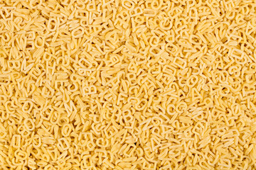 texture of raw alphabet abc letter noodles pasta italian food macro background